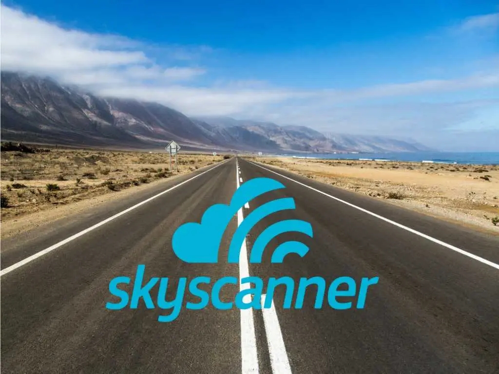 Skyscanner logo on photo of open road with mountains