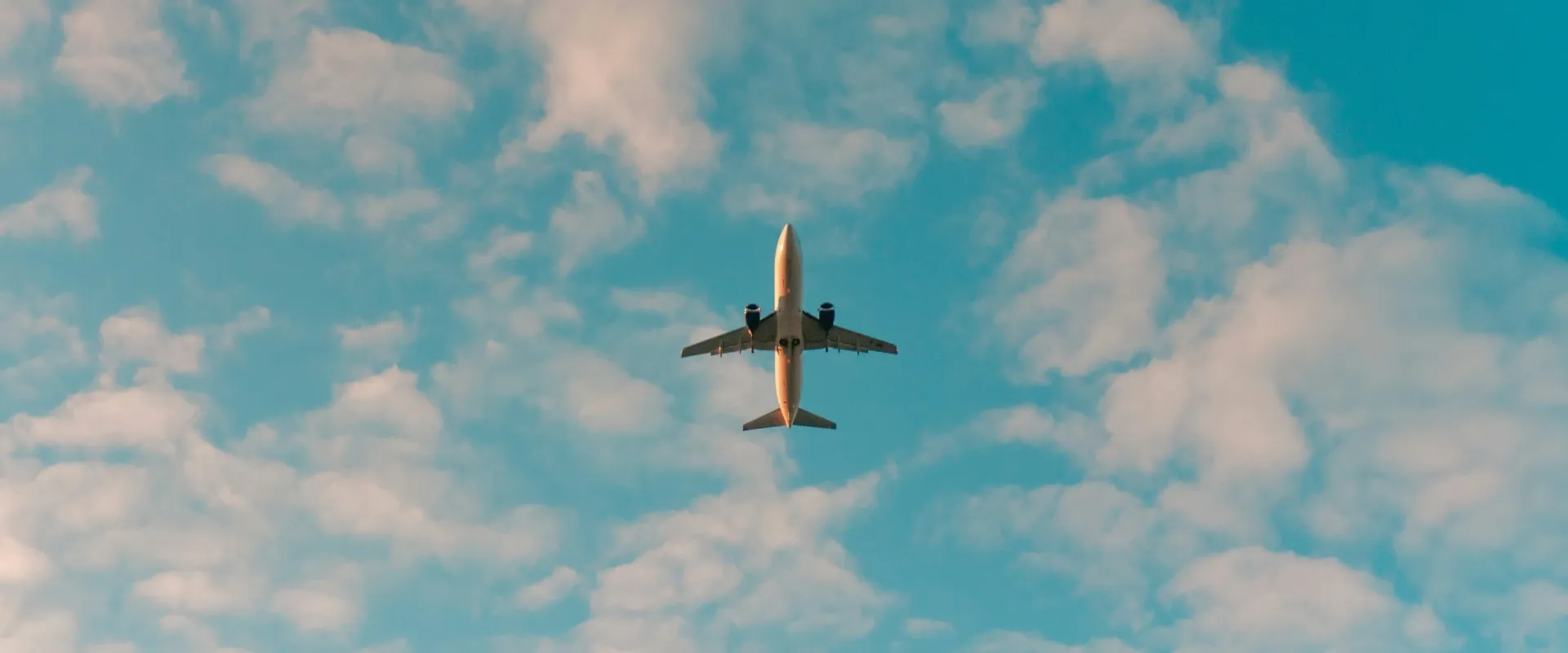 Plane flying in cloudy sky